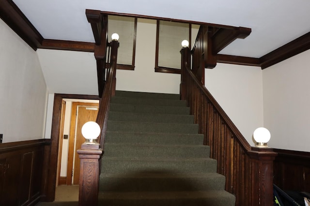 stairs featuring crown molding