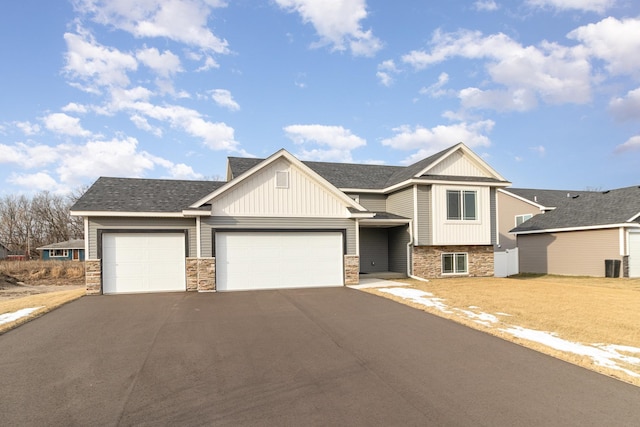 view of front facade featuring a garage and central AC