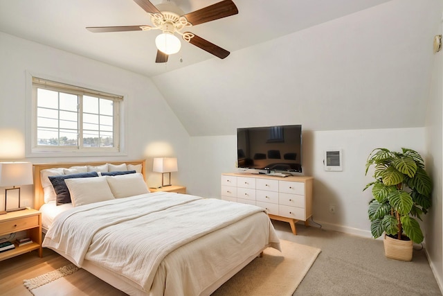 bedroom featuring vaulted ceiling, a ceiling fan, and baseboards