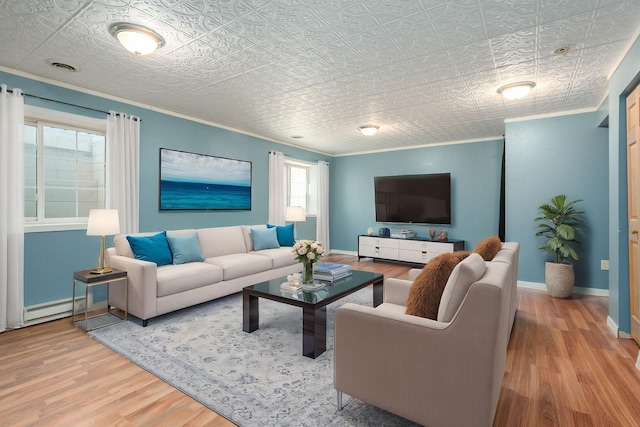 living room featuring baseboards, visible vents, wood finished floors, crown molding, and a baseboard heating unit