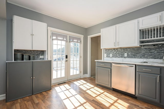 kitchen featuring french doors, stainless steel dishwasher, decorative backsplash, and gray cabinetry