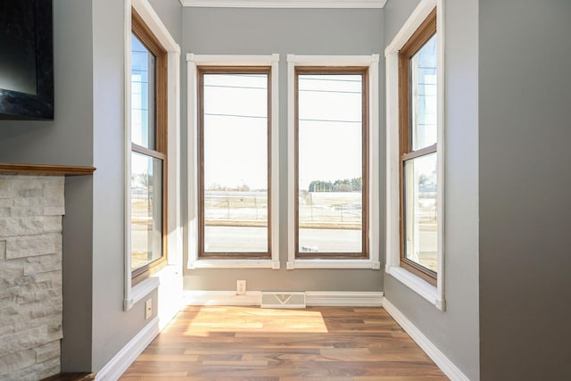 entryway featuring visible vents, baseboards, and wood finished floors