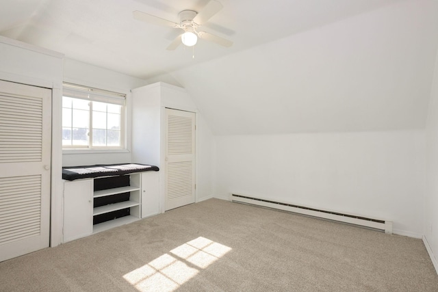 additional living space featuring light carpet, ceiling fan, baseboard heating, and vaulted ceiling