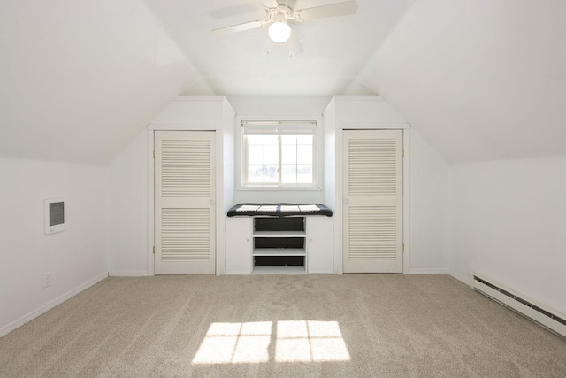 bonus room with ceiling fan, a baseboard heating unit, visible vents, vaulted ceiling, and carpet