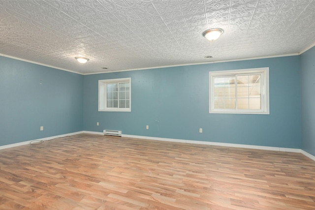 empty room featuring a baseboard radiator, baseboards, wood finished floors, and ornamental molding