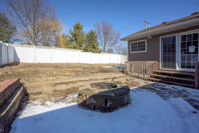 view of yard featuring entry steps, a fire pit, and a fenced backyard