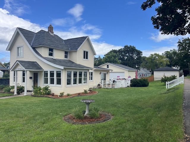 back of house featuring a yard and a garage