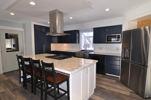 kitchen featuring island exhaust hood, a breakfast bar area, black appliances, a kitchen island, and sink