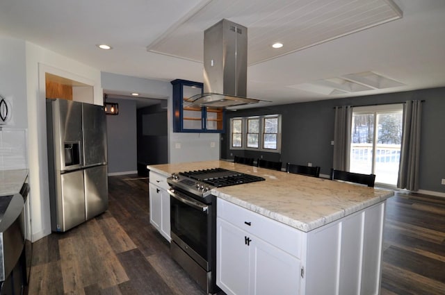 kitchen featuring stainless steel appliances, white cabinets, island exhaust hood, dark hardwood / wood-style floors, and a kitchen island