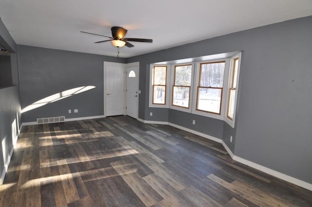 spare room featuring ceiling fan and dark wood-type flooring