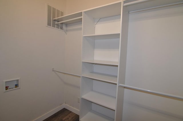 walk in closet featuring dark hardwood / wood-style floors