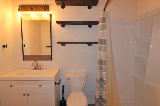 bathroom with toilet, vanity, and a shower with curtain