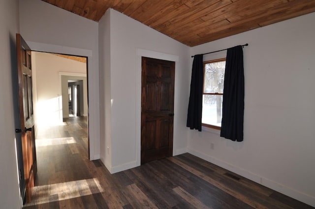 interior space with wood ceiling, dark wood-type flooring, a closet, and lofted ceiling