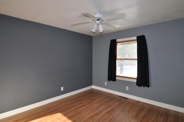 empty room with wood-type flooring and ceiling fan