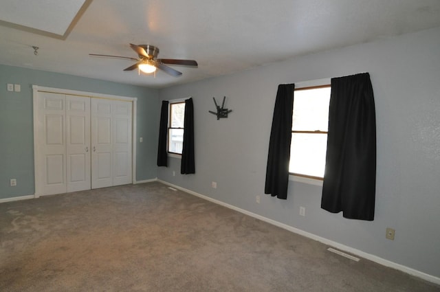 unfurnished bedroom with multiple windows, ceiling fan, and carpet flooring