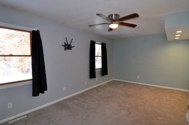 unfurnished room featuring ceiling fan and carpet flooring