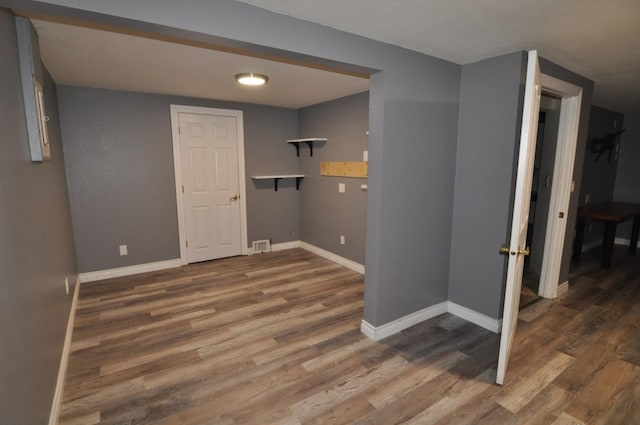 clothes washing area with dark hardwood / wood-style flooring