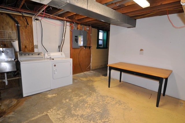 laundry room featuring electric panel, independent washer and dryer, and sink