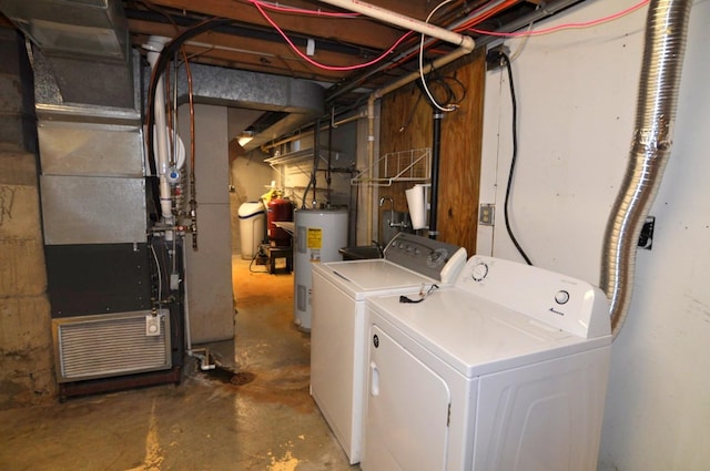 clothes washing area with washing machine and dryer, water heater, and heating unit