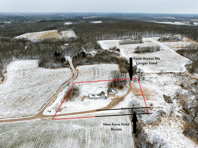 snowy aerial view featuring a rural view