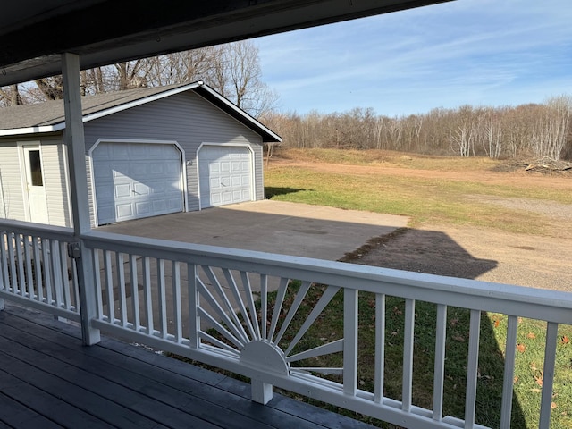 deck with a yard, an outdoor structure, and a garage