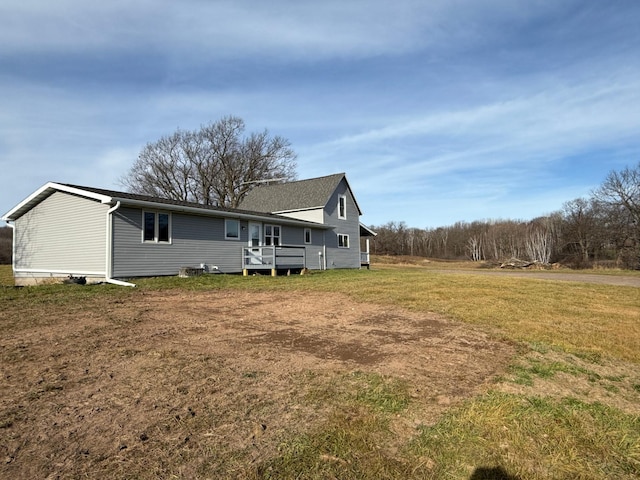 rear view of property with a yard