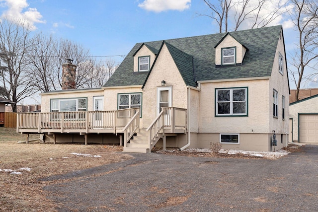 view of front facade with a wooden deck and a garage