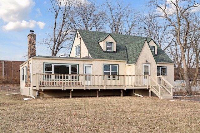 view of front of house featuring a deck and a front yard