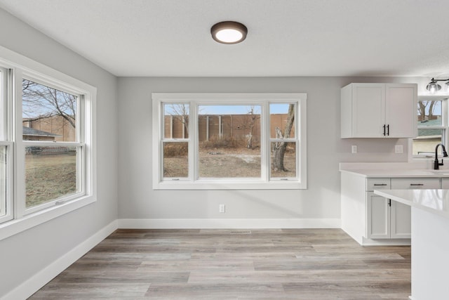 unfurnished dining area with sink and a textured ceiling