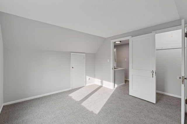 additional living space with lofted ceiling and light carpet