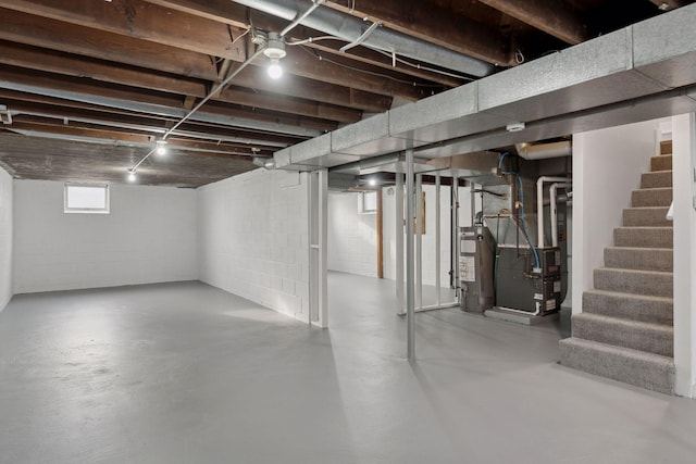 basement with water heater and heating unit