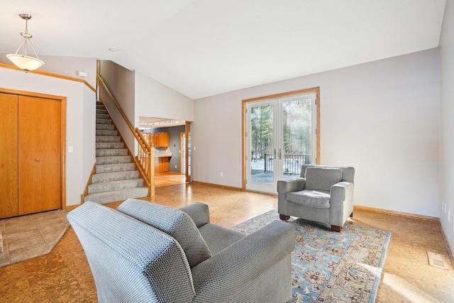 living room with lofted ceiling and french doors