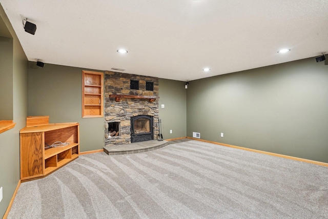 living room featuring a fireplace and carpet