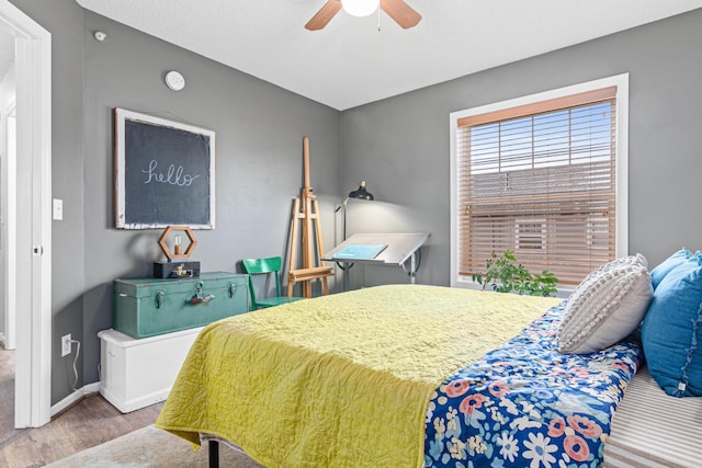 bedroom featuring ceiling fan and light hardwood / wood-style flooring