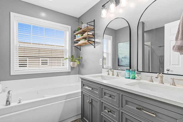 bathroom with plenty of natural light, vanity, and plus walk in shower