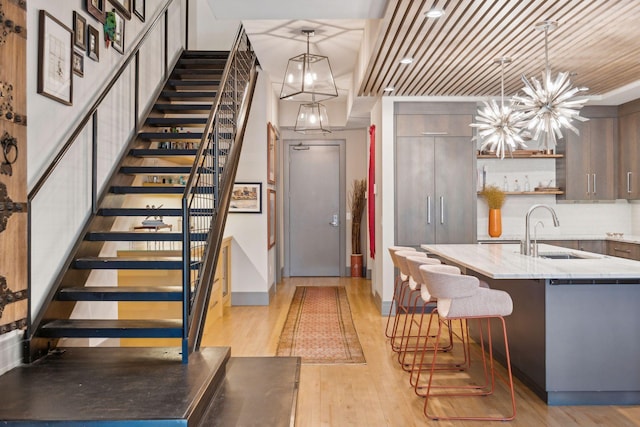 interior space featuring wooden ceiling, a chandelier, wood-type flooring, and sink