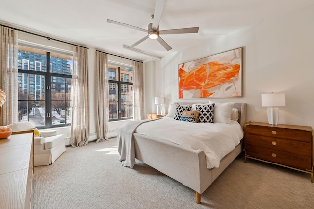 bedroom featuring ceiling fan, light carpet, and multiple windows