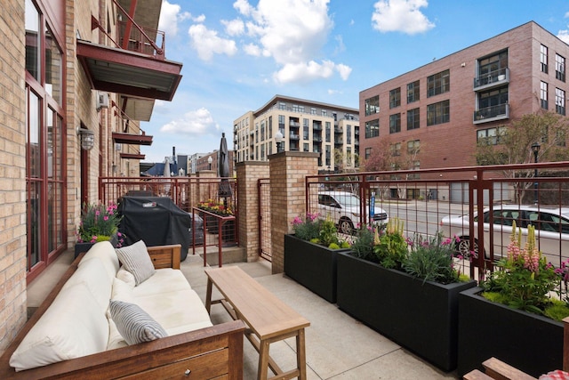 view of patio / terrace with an outdoor living space, area for grilling, and a balcony
