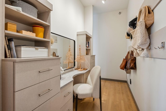 interior space with light wood-style floors and built in desk