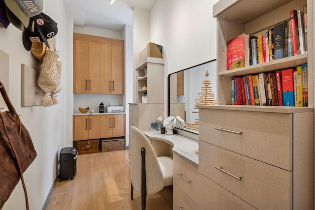 office featuring built in study area and light wood-type flooring