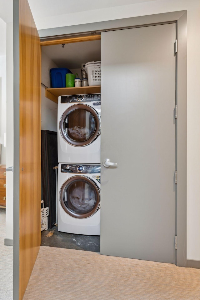 washroom with stacked washer / drying machine and laundry area