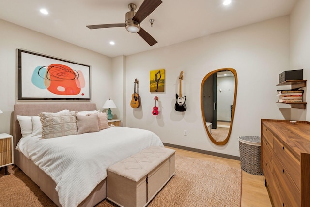 bedroom with ceiling fan, arched walkways, baseboards, light wood-style floors, and recessed lighting