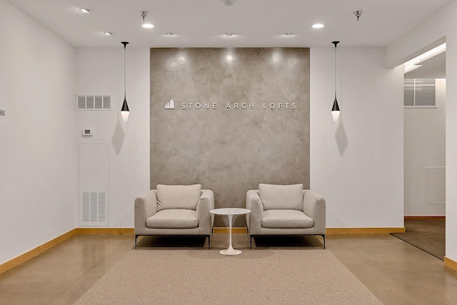 living area featuring recessed lighting, baseboards, concrete floors, and visible vents