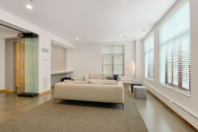 living room featuring visible vents, baseboards, recessed lighting, finished concrete floors, and a baseboard radiator