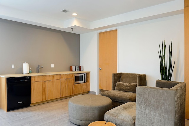 bar with visible vents, dishwasher, a sink, stainless steel microwave, and recessed lighting