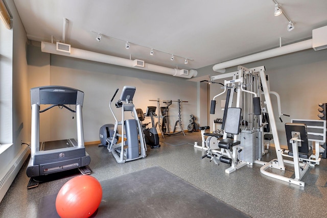 workout area with baseboard heating, rail lighting, and visible vents