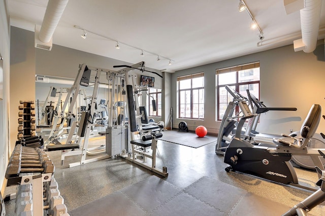 gym featuring track lighting, baseboards, and visible vents