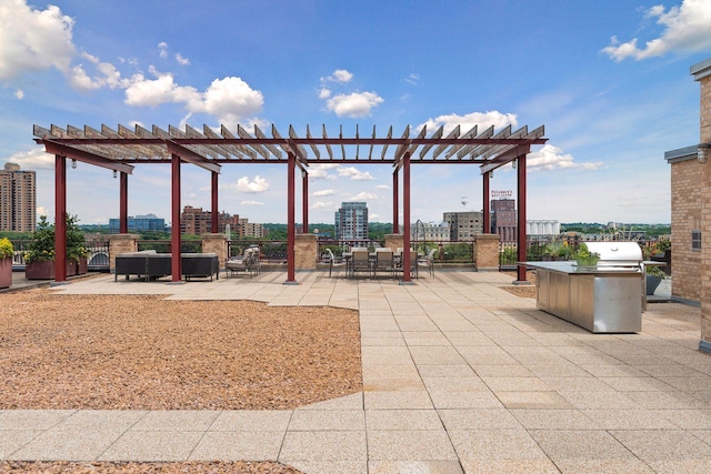 view of patio with a view of city, grilling area, and a pergola