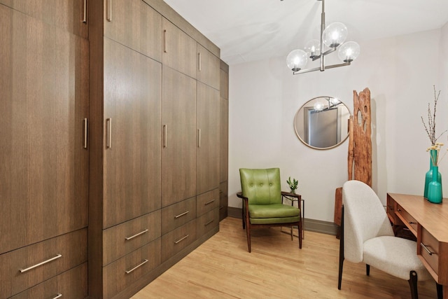 home office with baseboards, light wood-style flooring, and a chandelier