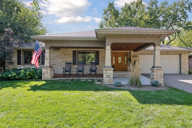 view of front of home with a porch, an attached garage, a front lawn, stone siding, and aphalt driveway